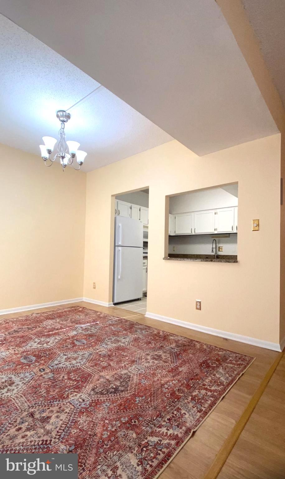 11839 Shire Court, Unit 2C Reston, VA 20191 - Photo 18 of 60 a view of a room with an empty space and a chandelier fan