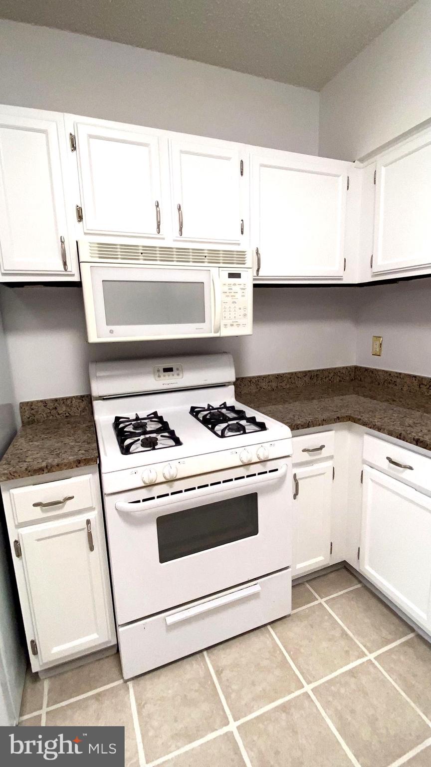 11839 Shire Court, Unit 2C Reston, VA 20191 - Photo 19 of 60 a white stove top oven sitting inside of a kitchen
