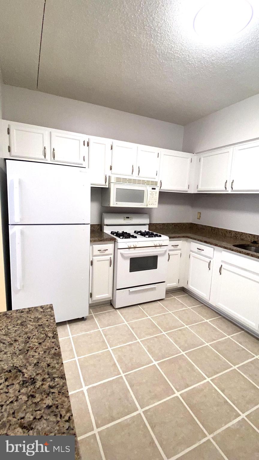 11839 Shire Court, Unit 2C Reston, VA 20191 - Photo 24 of 60 a white cabinets with wooden floor