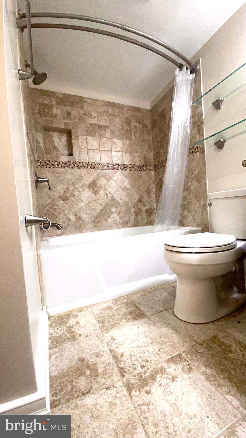 11839 Shire Court, Unit 2C Reston, VA 20191 - Photo 31 of 60 a bathroom with a bathtub and a shower