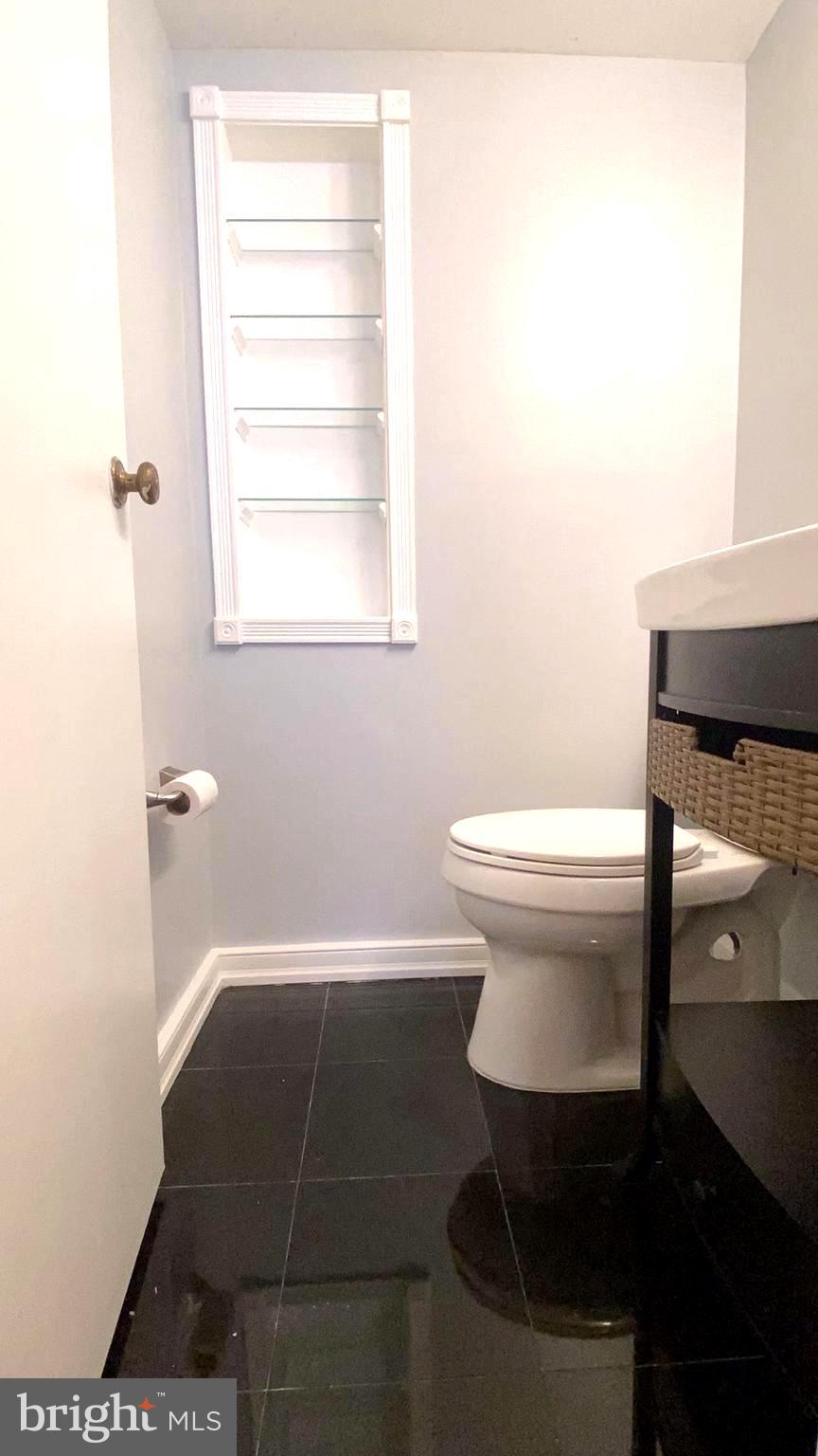 11839 Shire Court, Unit 2C Reston, VA 20191 - Photo 34 of 60 a bathroom with a toilet a sink and a window