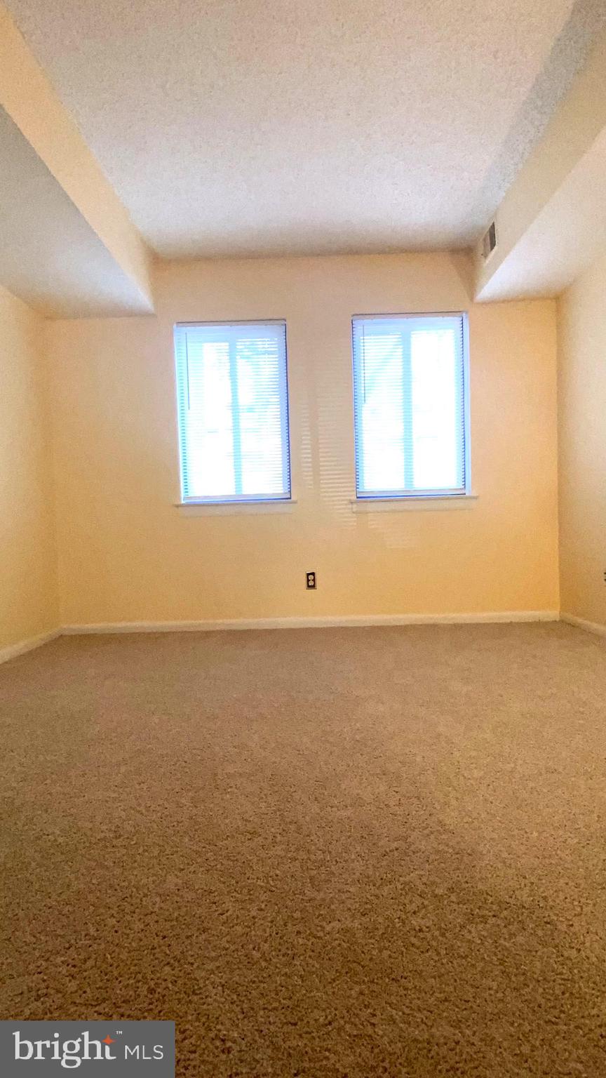11839 Shire Court, Unit 2C Reston, VA 20191 - Photo 40 of 60 an empty room with a natural light