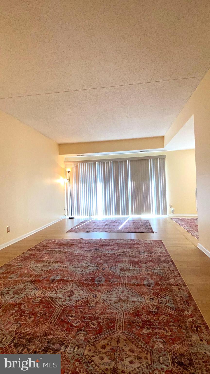 11839 Shire Court, Unit 2C Reston, VA 20191 - Photo 46 of 60 a view of an empty room with window and wooden floor