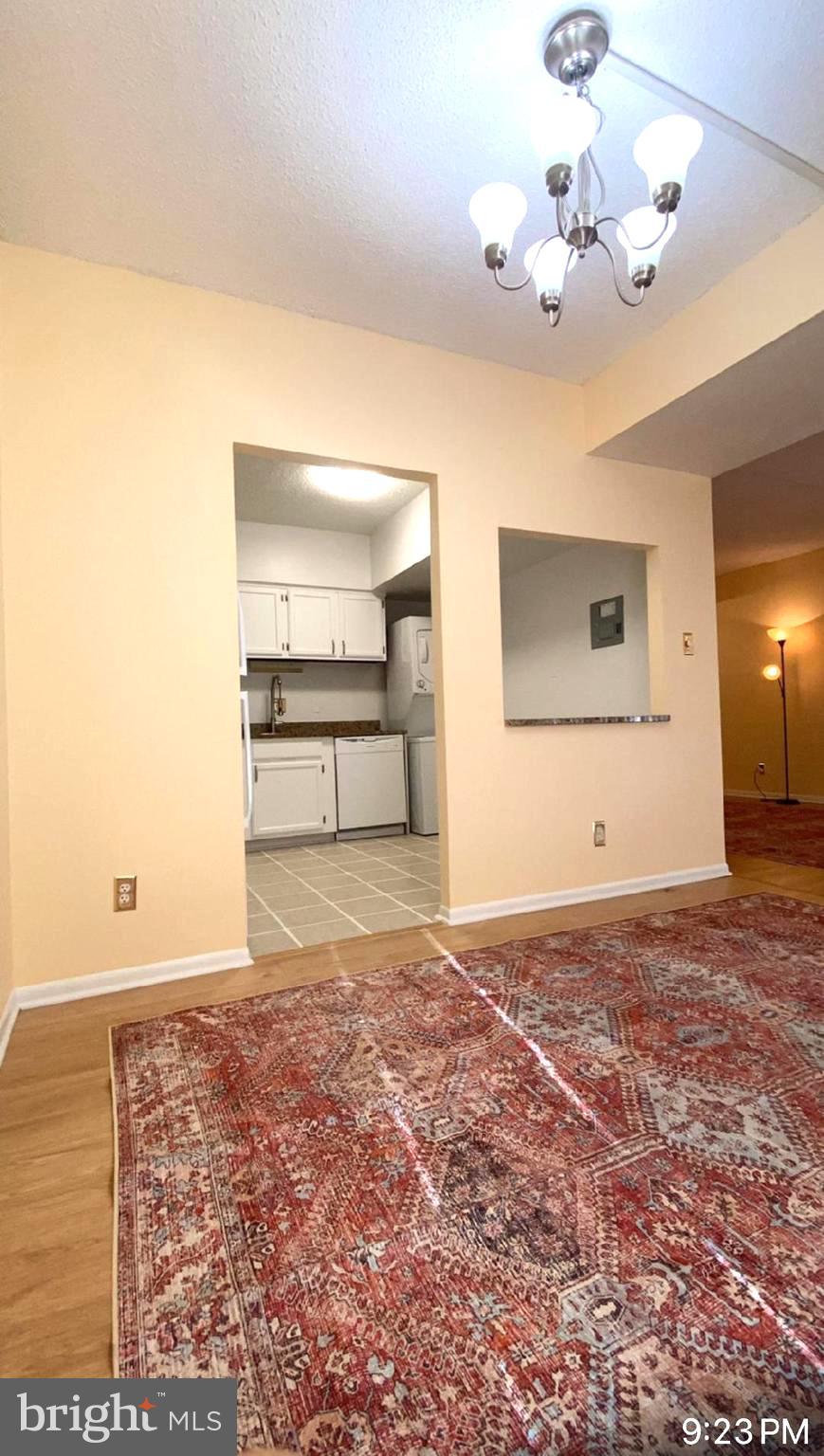 11839 Shire Court, Unit 2C Reston, VA 20191 - Photo 54 of 60 a view of a room with a chandelier fan and wooden floor
