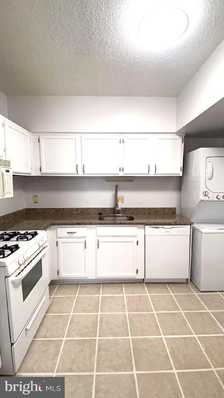 11839 Shire Court, Unit 2C Reston, VA 20191 - Photo 55 of 60 a view of a kitchen with a stove and white cabinets