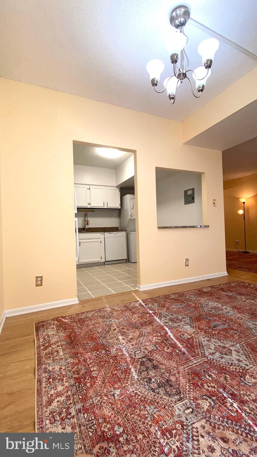 11839 Shire Court, Unit 2C Reston, VA 20191 - Photo 10 of 60 a view of a big room with wooden floor and chandelier fan