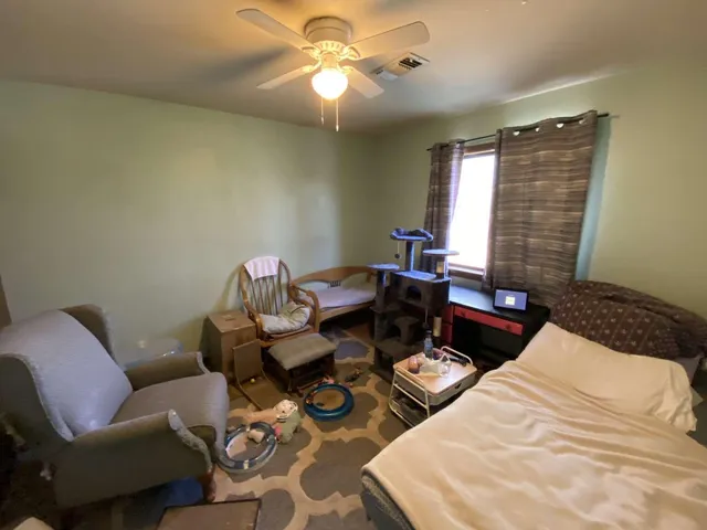 a bedroom with furniture and a window