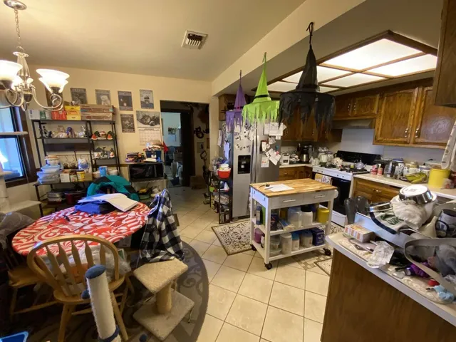 a living room with furniture a flat screen tv and a window