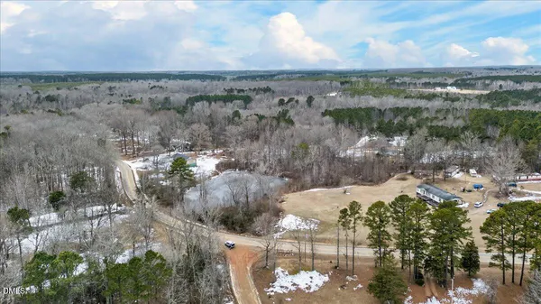 a view of a yard with wooden fence