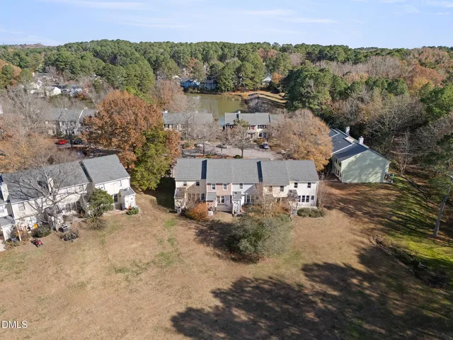 an aerial view of a house with a yard and lake view