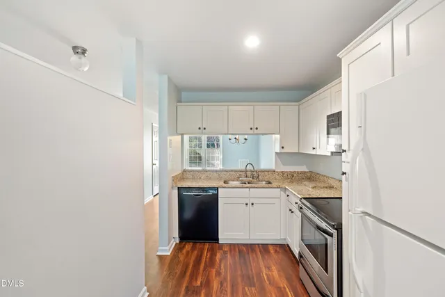 a kitchen with stainless steel appliances granite countertop a sink and cabinets