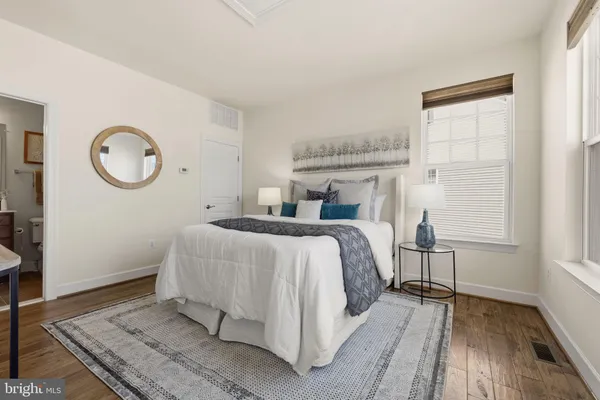 a bedroom with a bed and window