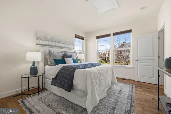 a bedroom with a large bed and a large window