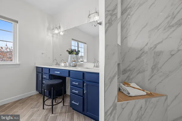 a bathroom with a sink a mirror a toilet and shower