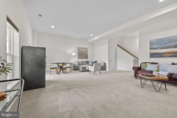 a view of a terrace with furniture and a garden