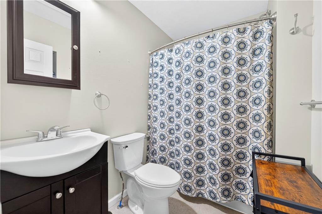 1 6th Avenue Freedom, PA 15042 - Photo 13 of 20 a bathroom with a sink toilet and a mirror