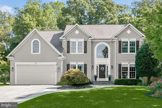 a front view of a house with a garden and plants