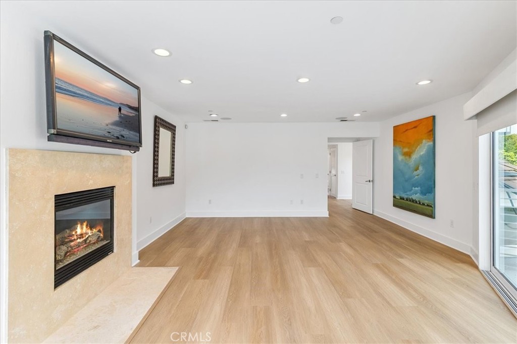 362 Pinecrest Drive Laguna Beach, CA 92651 - Photo 23 of 32 a view of empty room with wooden floor and fireplace