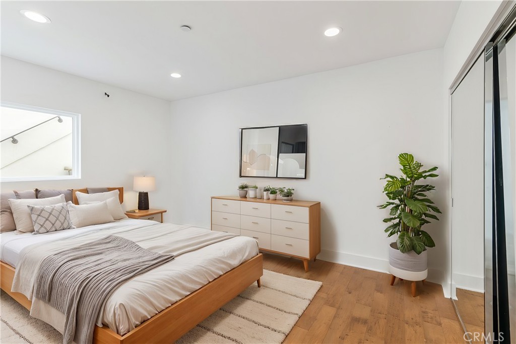 362 Pinecrest Drive Laguna Beach, CA 92651 - Photo 25 of 32 a bedroom with a large bed and a potted plant