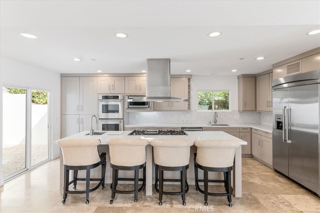 362 Pinecrest Drive Laguna Beach, CA 92651 - Photo 7 of 32 a kitchen with a dining table chairs refrigerator and cabinets