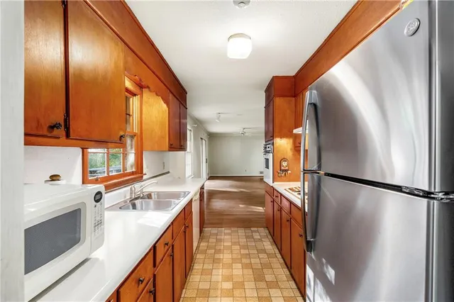 a kitchen with a refrigerator and a sink