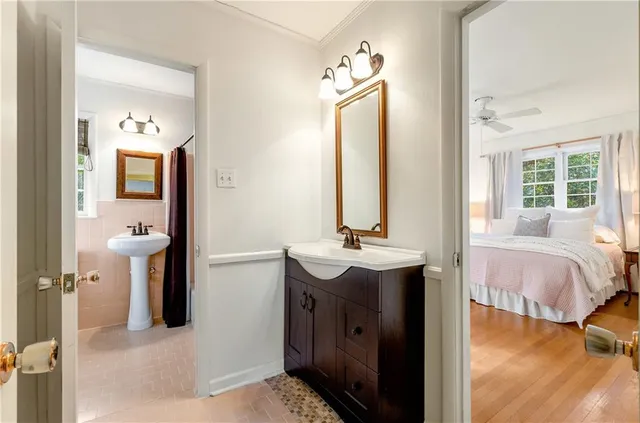 a en suite bathroom with a sink vanity and a mirror