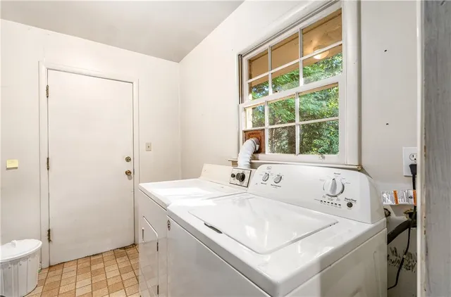 a utility room with a sink and a toilet