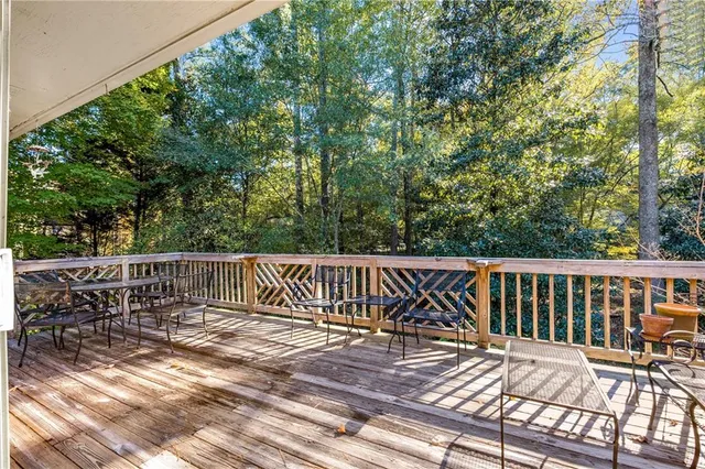 a view of balcony with wooden floor and fence