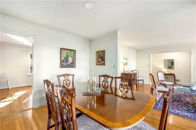 a dining room with furniture and wooden floor