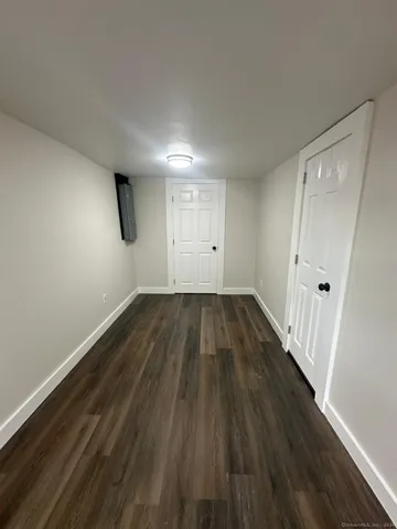 a view of a room with wooden floor and window