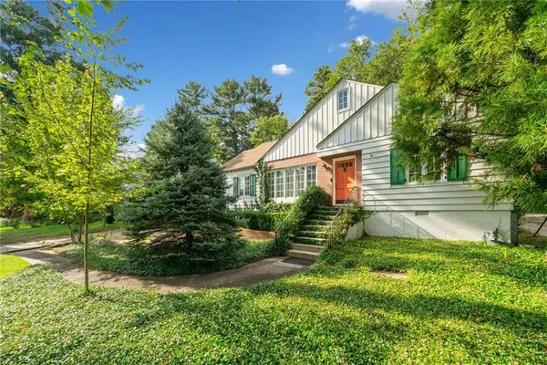 a front view of house with yard and green space