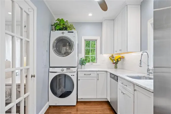 a utility room with sink dryer and washer