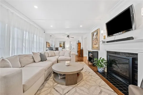 a living room with furniture a fireplace and a flat screen tv