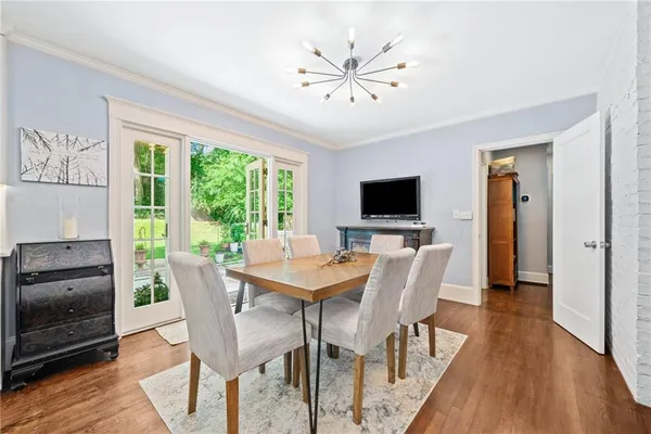 a view of a dining room with furniture window and wooden floor