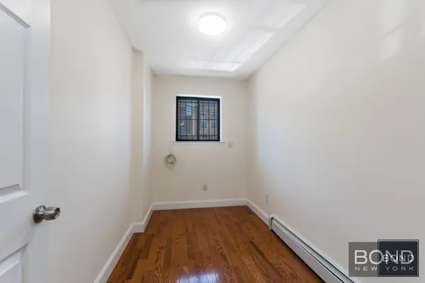 a view of a room with wooden floor and window
