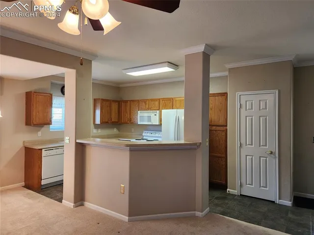 a kitchen with stainless steel appliances granite countertop a stove and a refrigerator