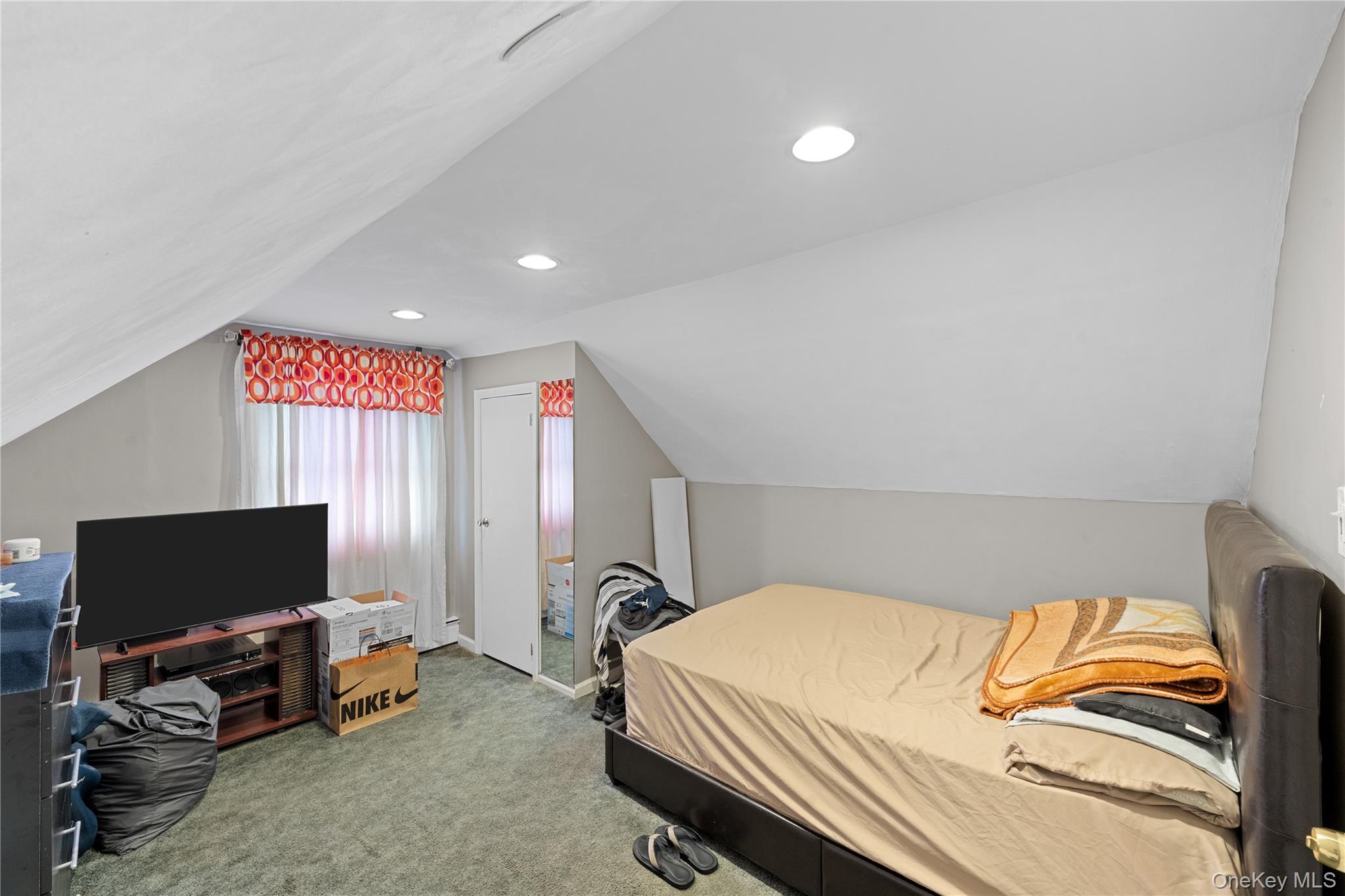 762 Buchanan Road East Meadow, NY 11554 - Photo 36 of 40 a bedroom with a bed and a flat screen tv