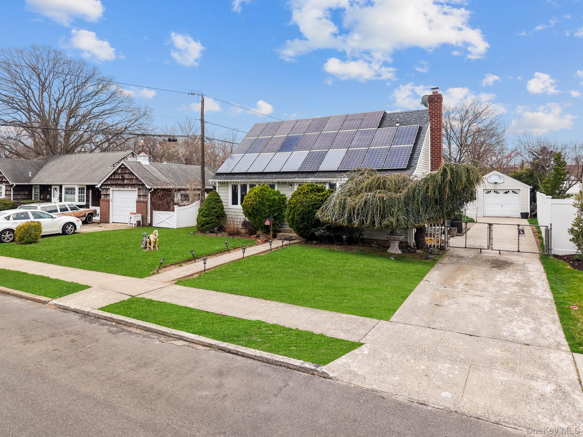 762 Buchanan Road East Meadow, NY 11554 - Photo 7 of 40 a front view of a house with a yard and garage