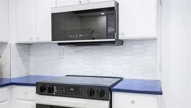 a living room with furniture and a painting on the wall