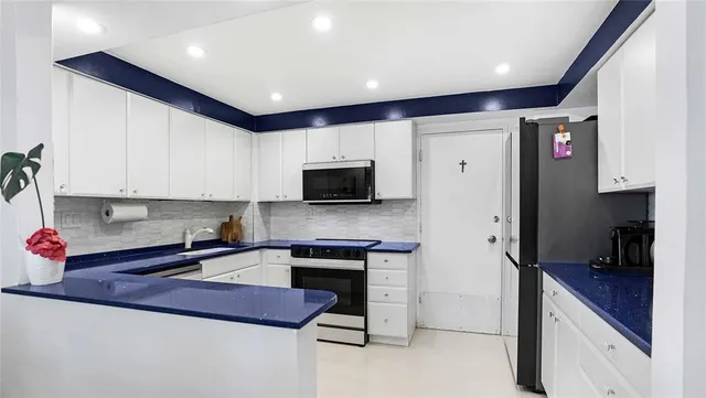 a view of backyard with swimming pool and seating space