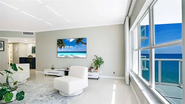 a living room with furniture and a large window