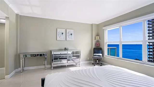a view of a patio with a table and chairs and potted plants