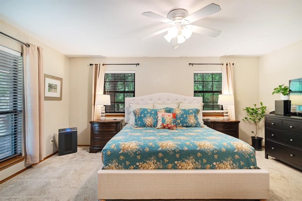 730 Cedar Creek Drive Reno, TX 75462 - Photo 11 of 28 a bedroom with a large bed and a chandelier