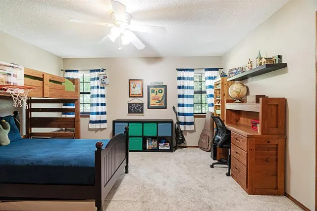 a bedroom with furniture and a flat screen tv