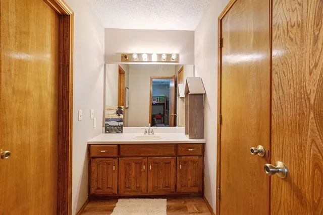 a bathroom with a double vanity sink and a mirror