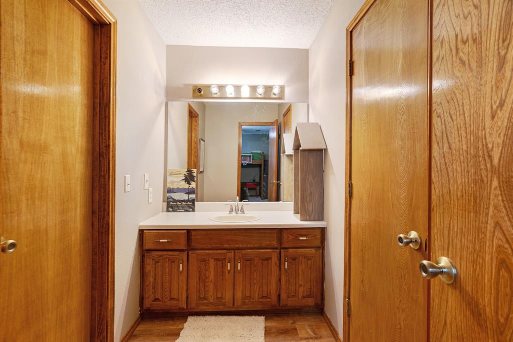 730 Cedar Creek Drive Reno, TX 75462 - Photo 17 of 28 a bathroom with a double vanity sink and a mirror