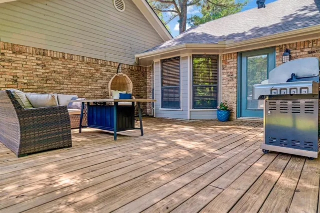 a view of a roof deck with chair and table