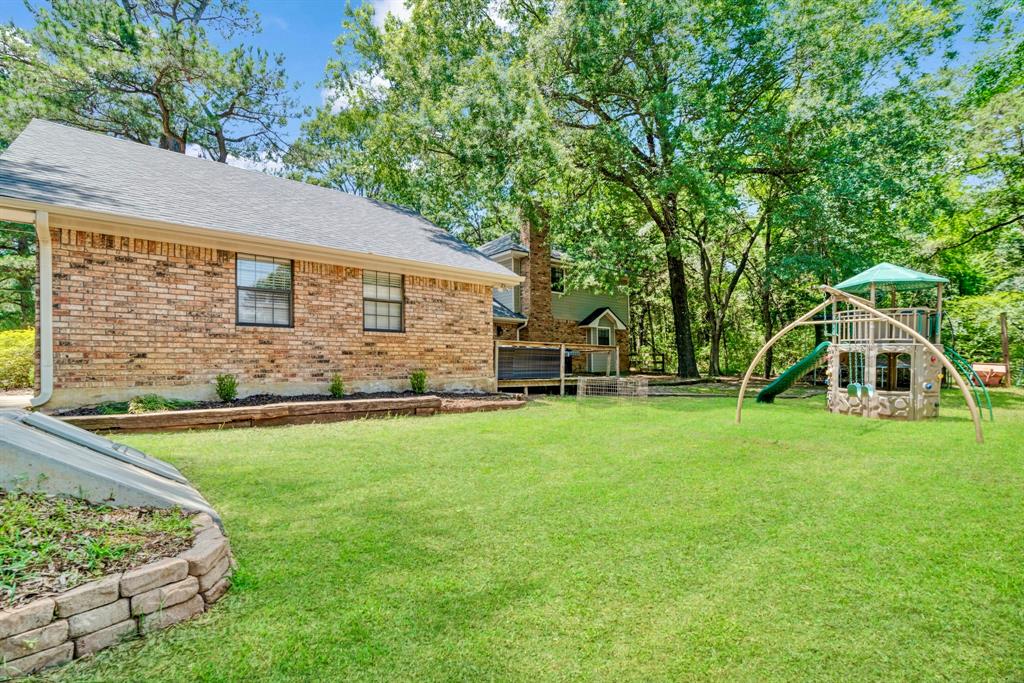 730 Cedar Creek Drive Reno, TX 75462 - Photo 22 of 28 a front view of house with yard and trees in the background
