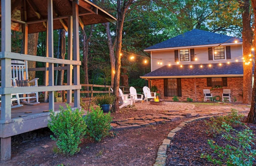 730 Cedar Creek Drive Reno, TX 75462 - Photo 26 of 28 a front view of a building with a garden