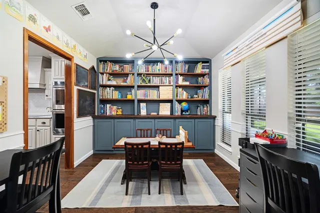a dining room with furniture and a book shelf